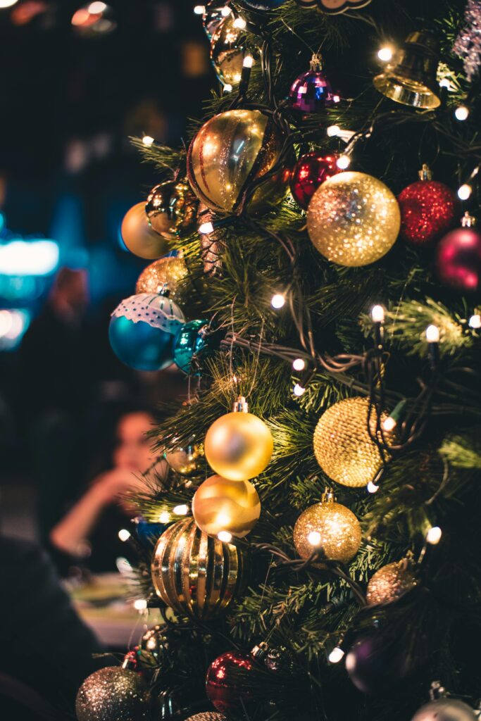 Close-up of a Christmas tree adorned with vibrant ornaments and lights.